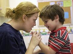 teacher working with autistic boy 