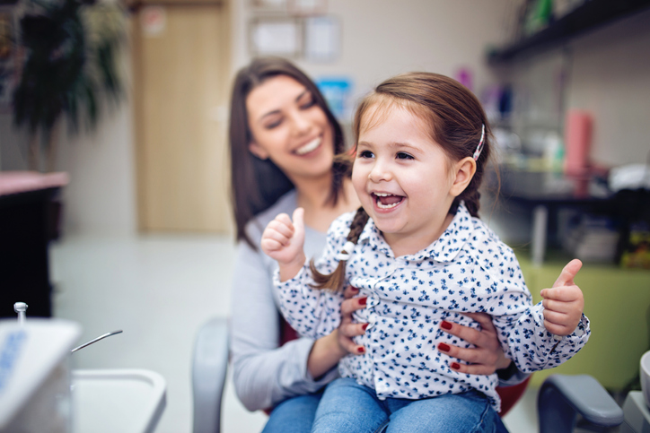 girl with autism giving thumbs up